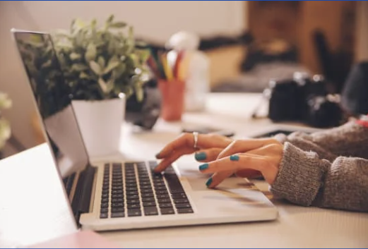 hands of a person working on a laptop